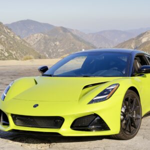 A lime green Lotus Emira at a highway lookout