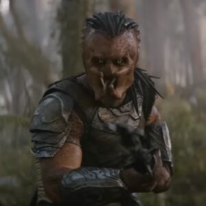 A Predator on an alien world brandishing a weapon