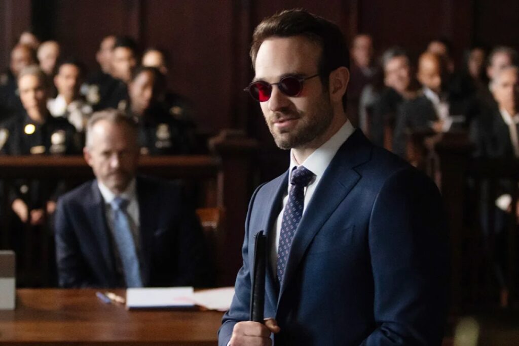 Blind man in a suit standing in a courtroom
