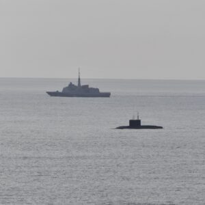 A French Navy vessel watches the surfaced Russian sub Novorossiysk this week.