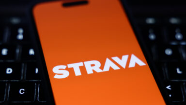 A laptop keyboard and Strava logo displayed on a phone screen are seen in this illustration photo taken in Krakow, Poland on January 15, 2025. (Photo by Jakub Porzycki/NurPhoto via Getty Images)