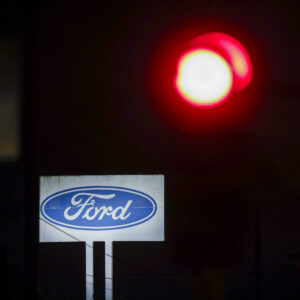 08 December 2025, North Rhine-Westphalia, Cologne: A logo of the car manufacturer Ford can be seen on a large sign of the Ford plant in Cologne. Photo: Thomas Banneyer/dpa (Photo by Thomas Banneyer/picture alliance via Getty Images)