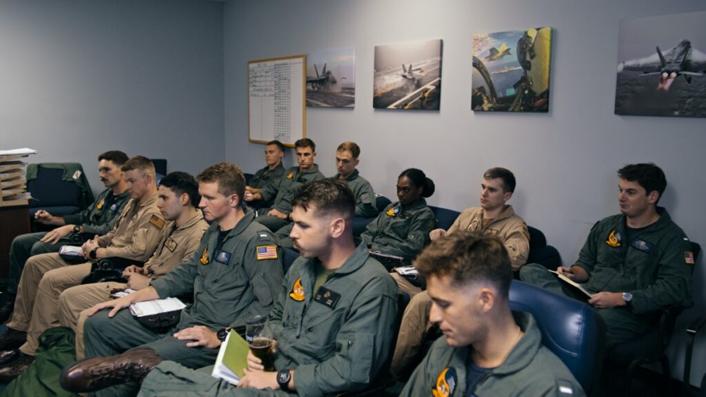 Students debrief in class at NAS Meridian.