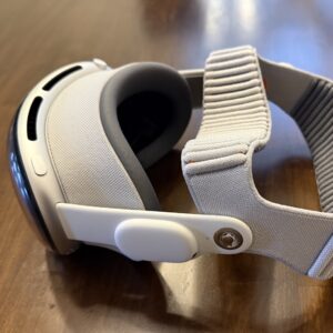 A headset sits on a wood table