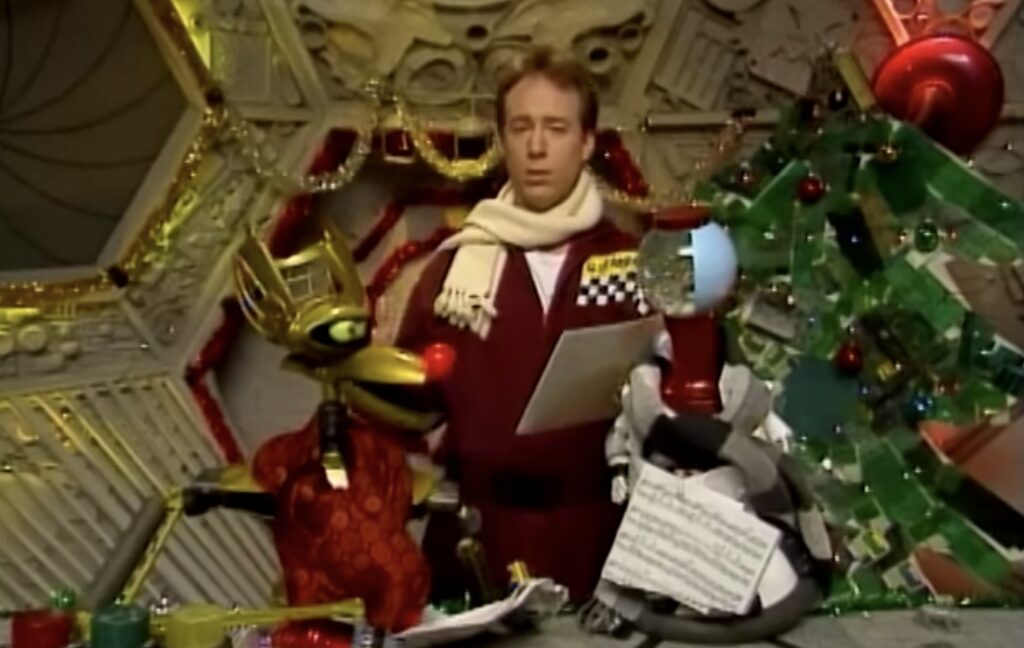 Joel and the bots by a Christmas tree