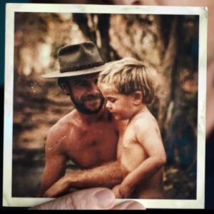 old photograph of man in a bush hat holding young son in the Australian outback