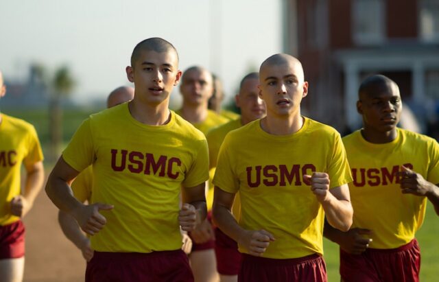 army boot camp recruits running as part of their training in yellow t shirts and red shorts
